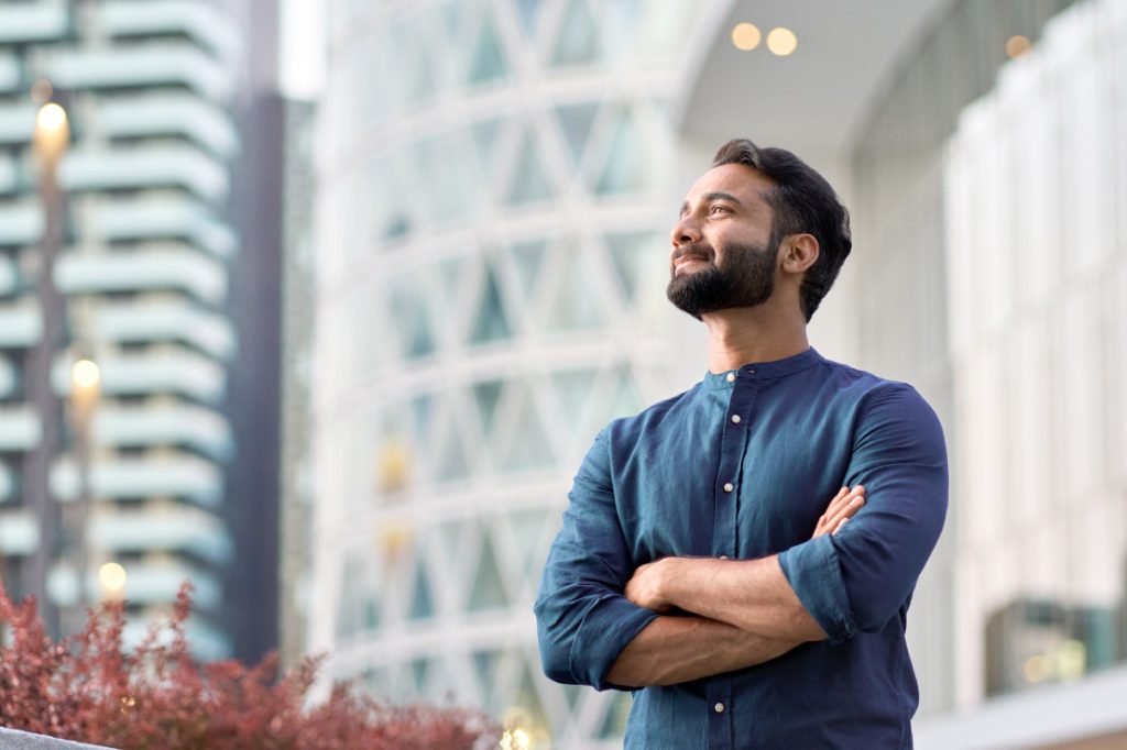 man happily looking out office window